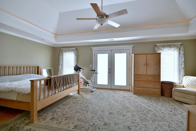 bedroom featuring ceiling fan, ornamental molding, access to exterior, french doors, and a raised ceiling