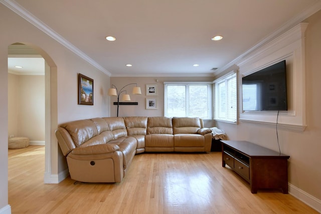 living area with arched walkways, baseboards, light wood-style floors, and ornamental molding