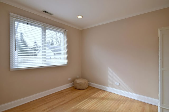 empty room featuring visible vents, crown molding, baseboards, light wood-type flooring, and recessed lighting