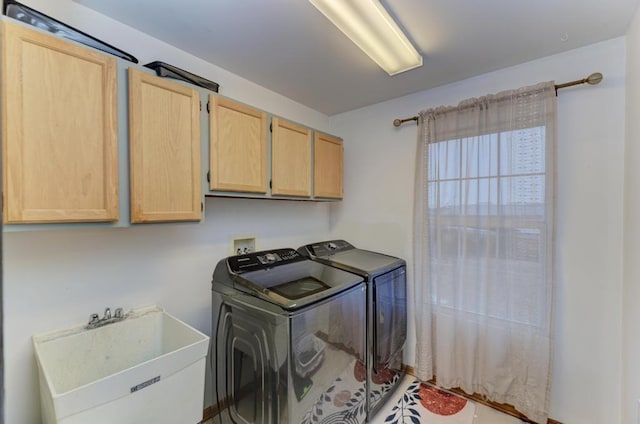 laundry room with cabinet space, a sink, and separate washer and dryer