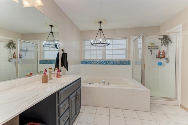 full bath featuring a garden tub, a notable chandelier, vanity, a shower stall, and tile patterned floors