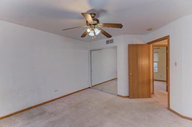 unfurnished bedroom featuring baseboards, visible vents, ceiling fan, carpet floors, and a closet