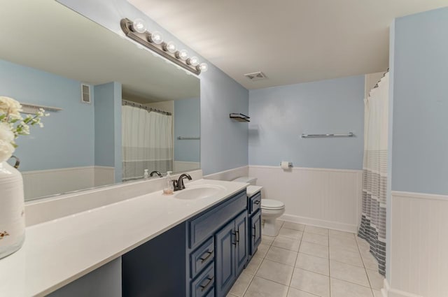 full bathroom featuring a wainscoted wall, tile patterned flooring, visible vents, and vanity