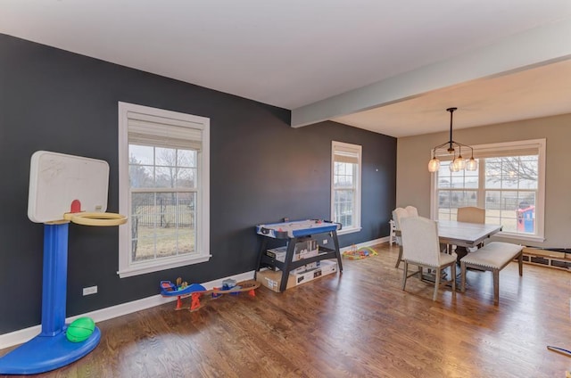 dining space featuring plenty of natural light, baseboards, and wood finished floors