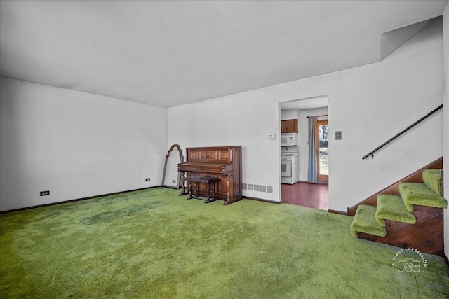 interior space featuring stairway, baseboards, and carpet