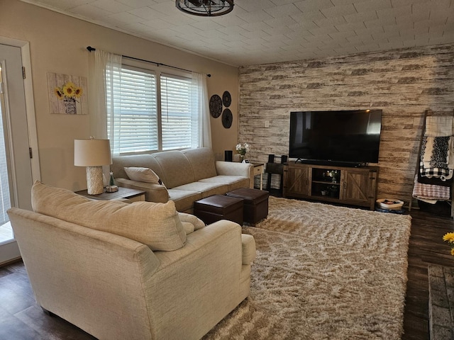 living area with wood finished floors and wood walls