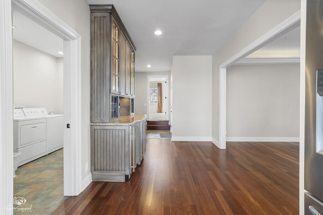 hallway with baseboards, dark wood-style flooring, washer and clothes dryer, and recessed lighting