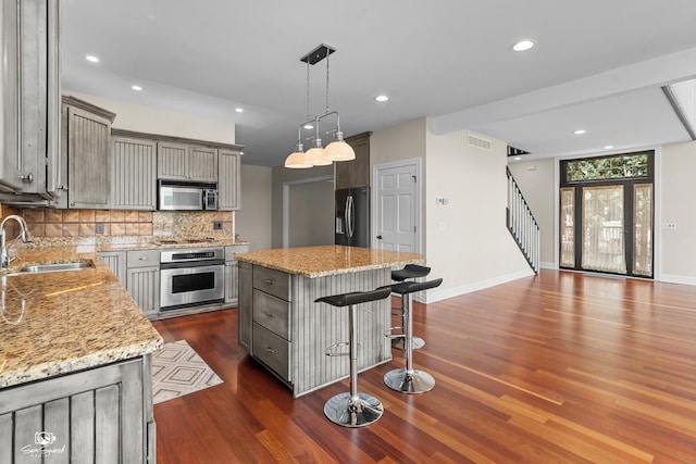 8043 Tamarack Ln, Morris, IL 60450 - kitchen featuring appliances with stainless steel finishes, gray cabinets, tasteful backsplash, dark wood-type flooring, and recessed lighting