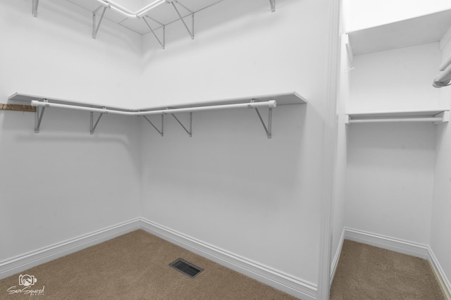 walk in closet with carpet floors and visible vents