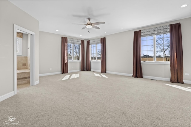 unfurnished bedroom with light carpet, multiple windows, and recessed lighting