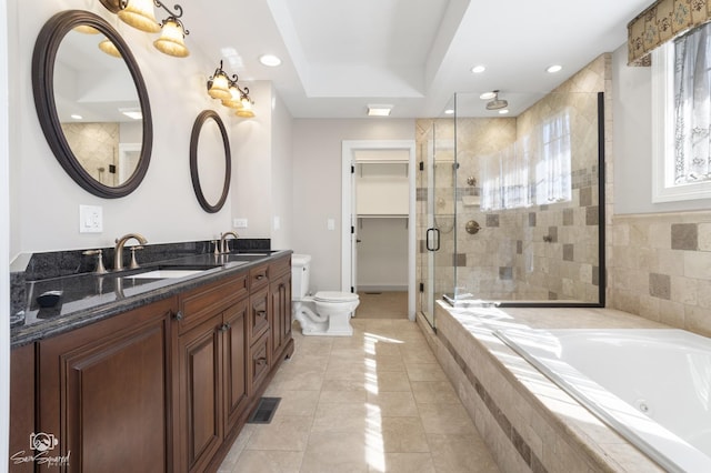 full bathroom with double vanity, a stall shower, visible vents, a bath, and a sink