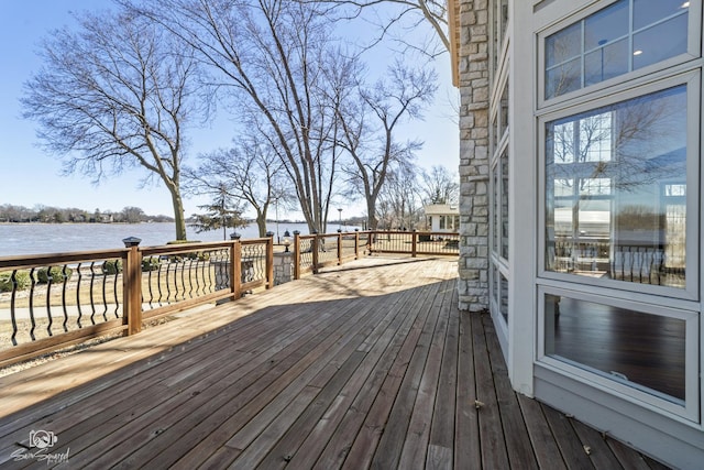 wooden deck featuring a water view