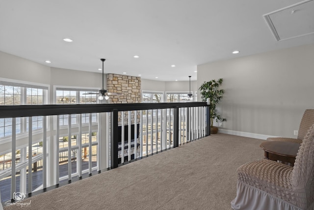 hallway with carpet floors, plenty of natural light, attic access, and recessed lighting