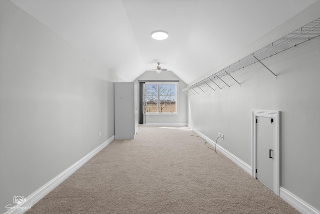 additional living space featuring vaulted ceiling, carpet flooring, and baseboards