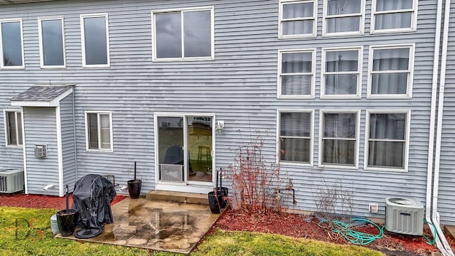 back of house with central AC and a patio area