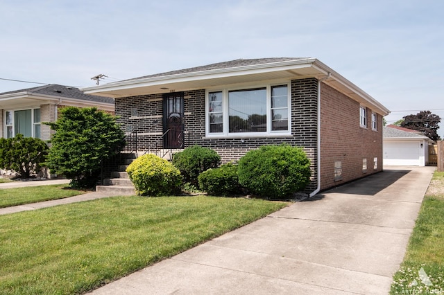 view of front of house with a front yard, an outdoor structure, crawl space, a detached garage, and brick siding