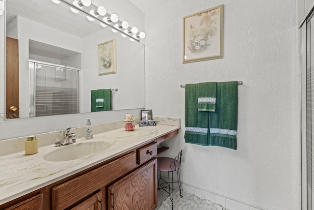 bathroom featuring vanity and a stall shower