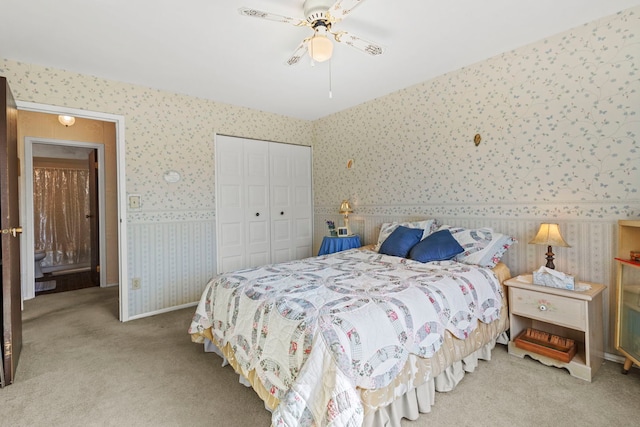 bedroom with a ceiling fan, baseboards, wallpapered walls, a closet, and carpet flooring