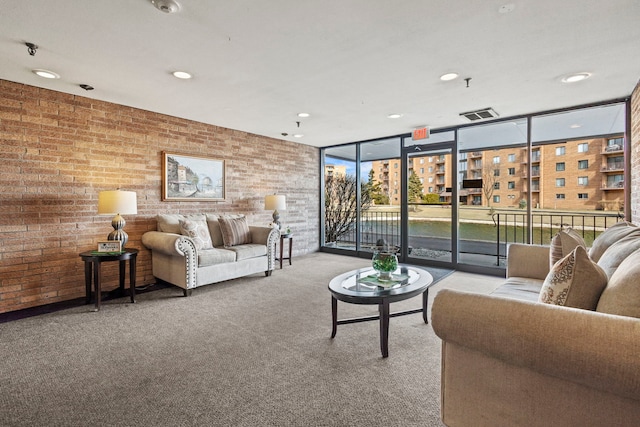 living area featuring recessed lighting, carpet flooring, floor to ceiling windows, and brick wall