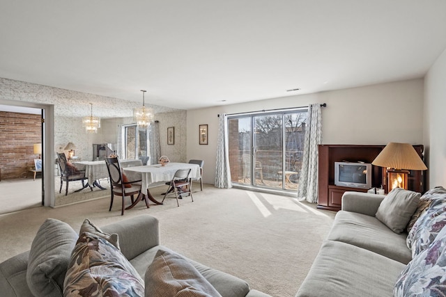 living room with light colored carpet and a chandelier