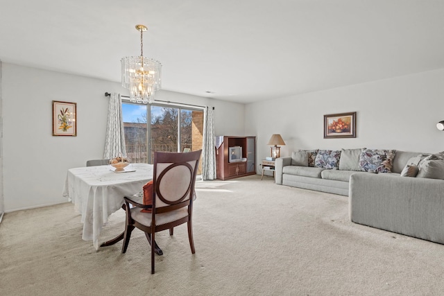 dining room with light carpet and a chandelier