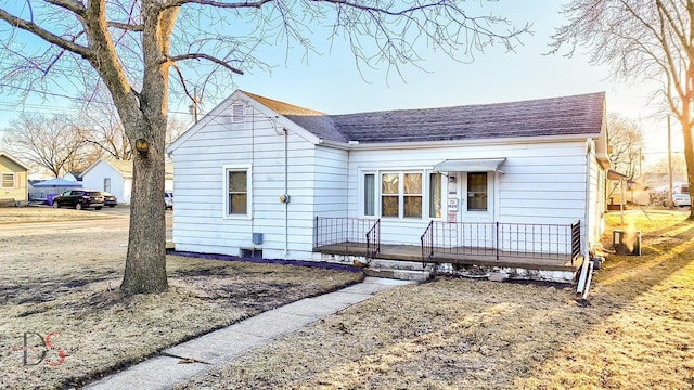 bungalow-style house featuring a shingled roof