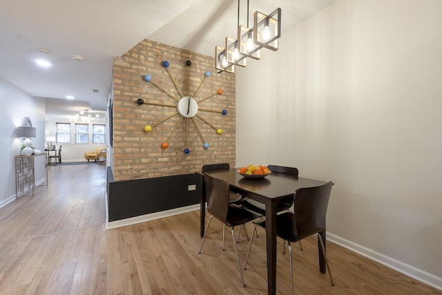 dining space featuring baseboards and wood finished floors