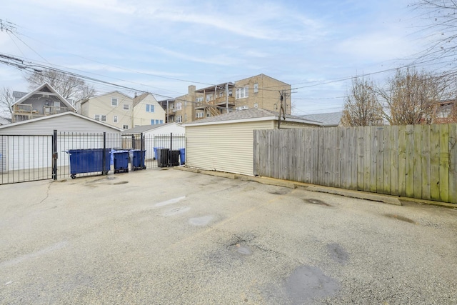 view of vehicle parking featuring fence