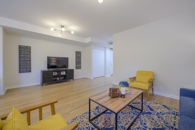 living area featuring visible vents, baseboards, and light wood finished floors