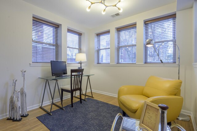 office area featuring visible vents, baseboards, and wood finished floors