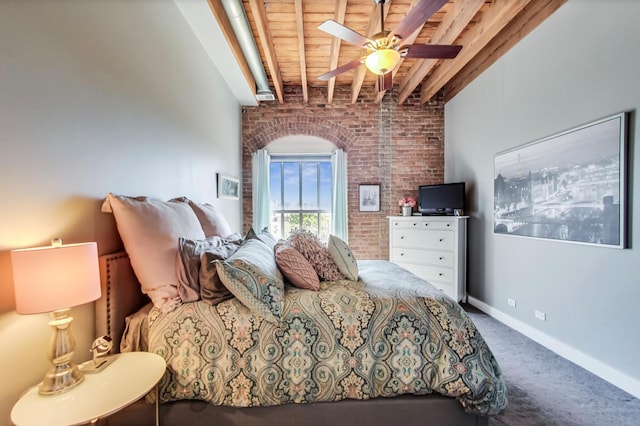 carpeted bedroom featuring beamed ceiling, brick wall, wooden ceiling, baseboards, and ceiling fan