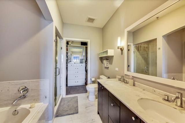 full bath with a sink, a stall shower, double vanity, and a bath