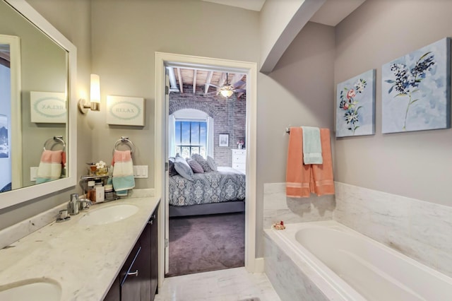 full bath featuring double vanity, a bath, ensuite bathroom, and a sink