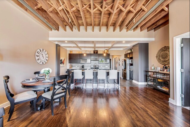 dining area with dark wood finished floors, beam ceiling, baseboards, and coffered ceiling