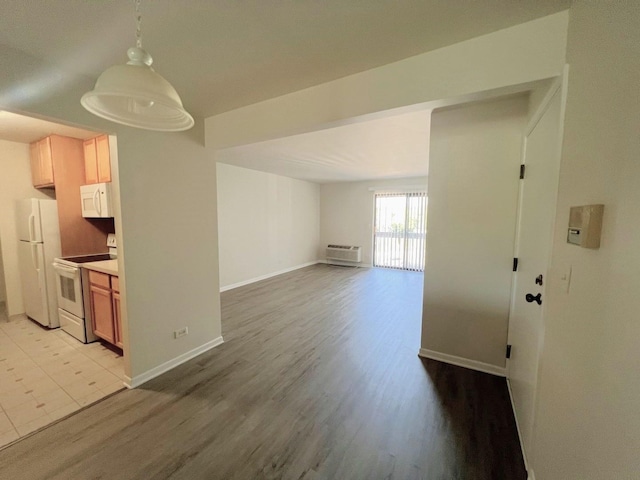 interior space with baseboards and light wood-style floors