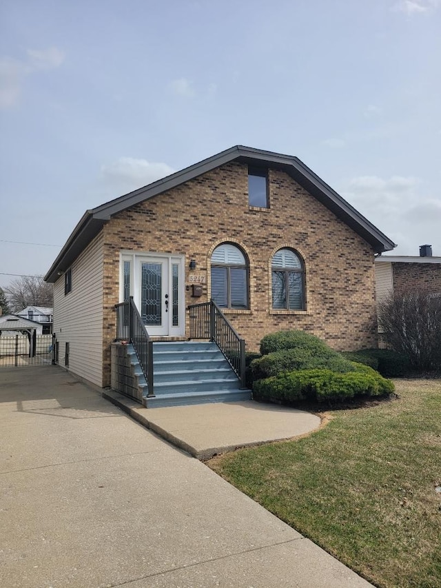 view of front of home featuring brick siding and driveway