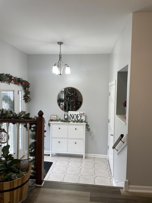 interior space featuring an inviting chandelier and baseboards