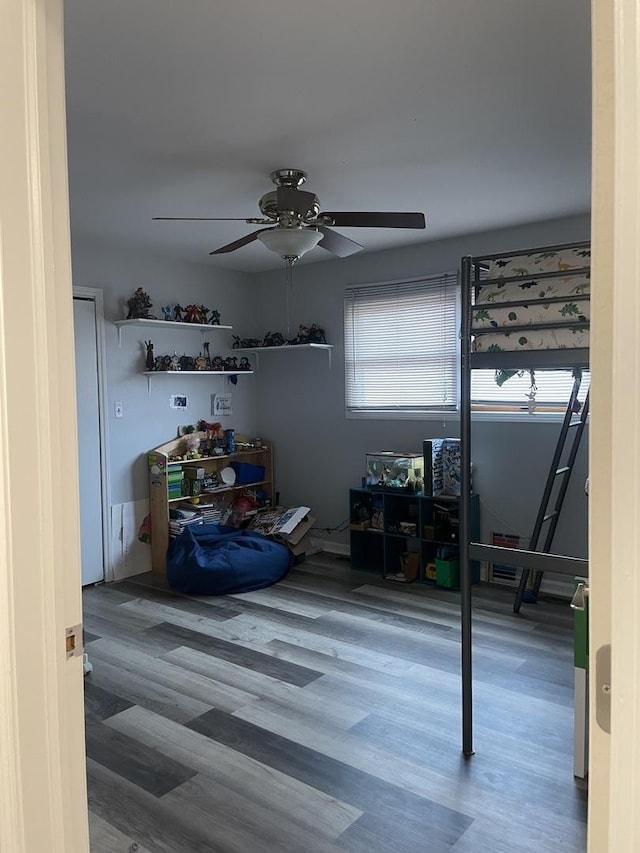 bedroom with ceiling fan and wood finished floors