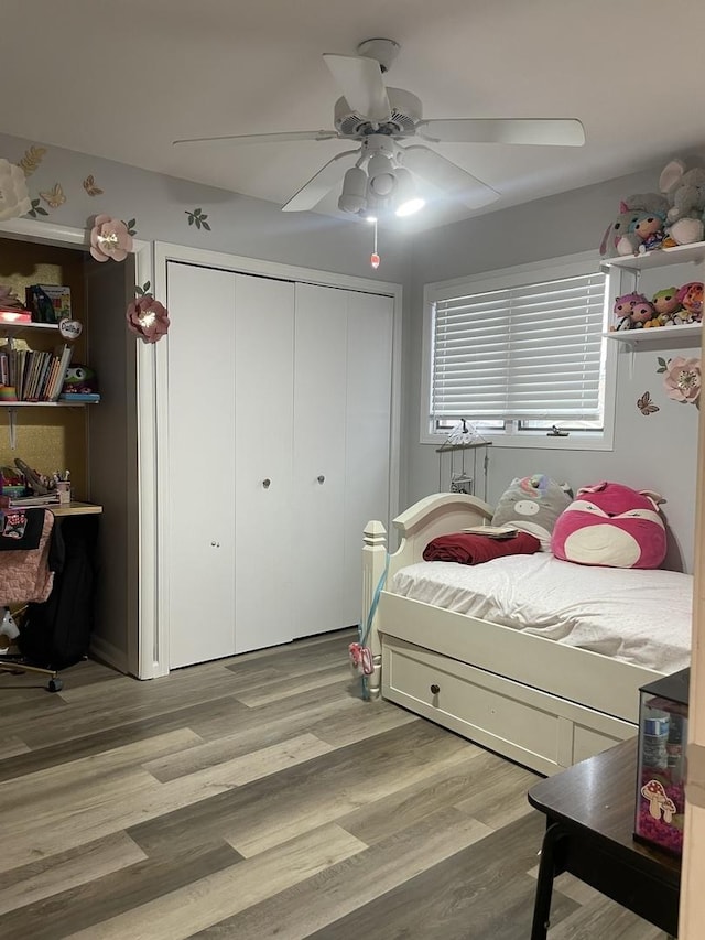 bedroom featuring a closet, a ceiling fan, and light wood finished floors