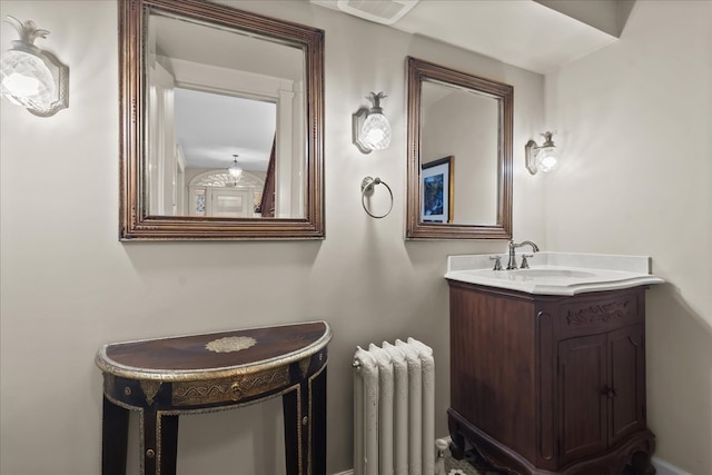 bathroom with visible vents, vanity, and radiator heating unit