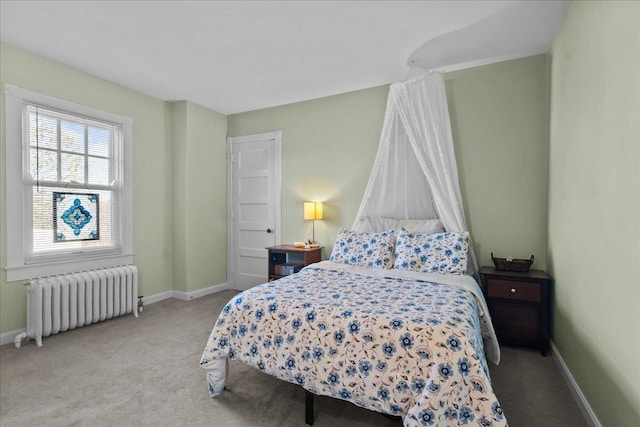 carpeted bedroom with radiator and baseboards