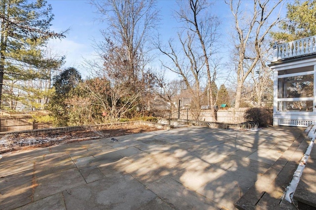 view of patio / terrace with a sunroom and fence