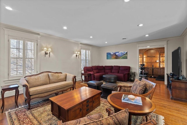 living room with light wood-style flooring, recessed lighting, and ornamental molding