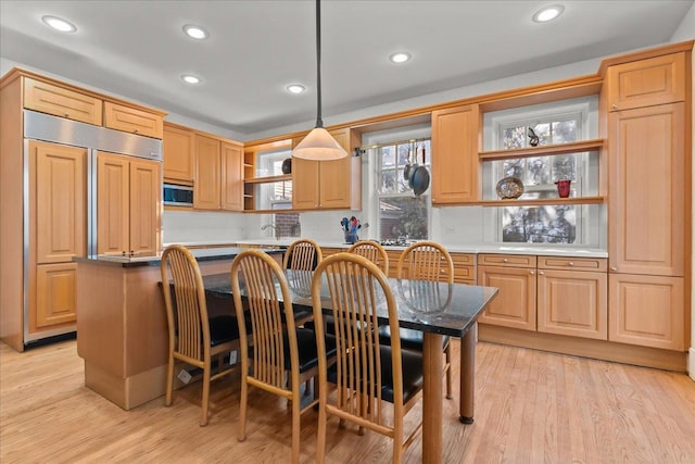 kitchen with light wood-style flooring, open shelves, stainless steel microwave, decorative light fixtures, and recessed lighting