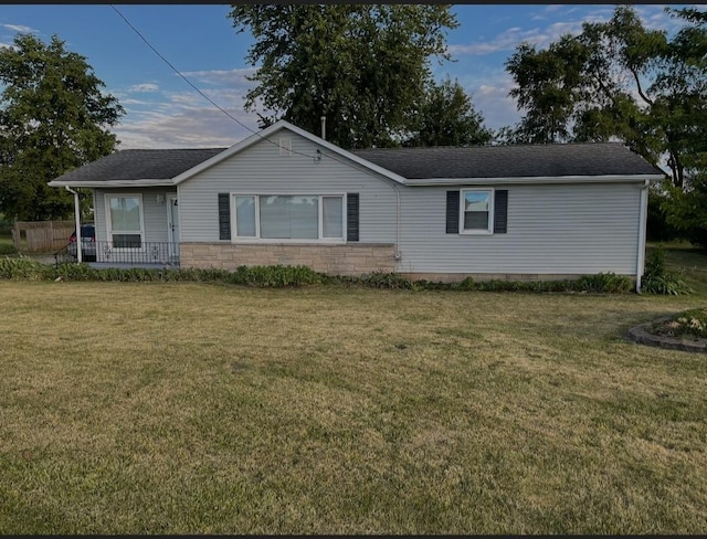 single story home with stone siding and a front yard