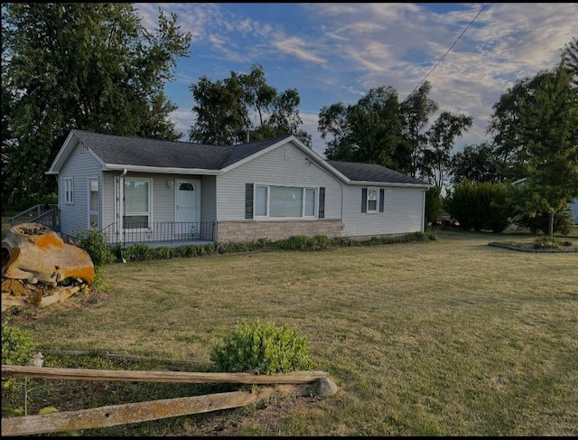 ranch-style home with stone siding, covered porch, and a front lawn