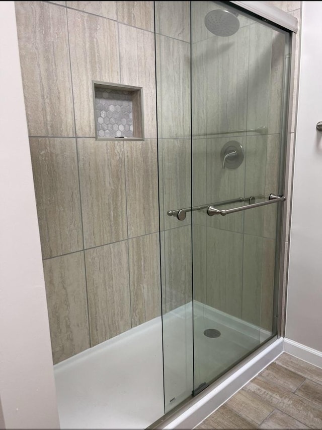 full bathroom with tiled shower