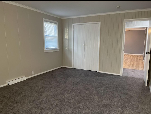 unfurnished bedroom featuring visible vents, dark carpet, a closet, and crown molding