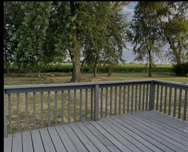 wooden deck featuring a yard