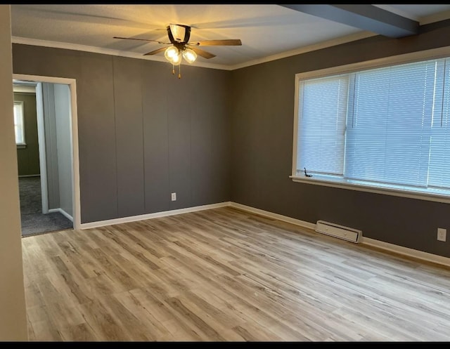 unfurnished room with ceiling fan, light wood-style flooring, baseboards, and ornamental molding